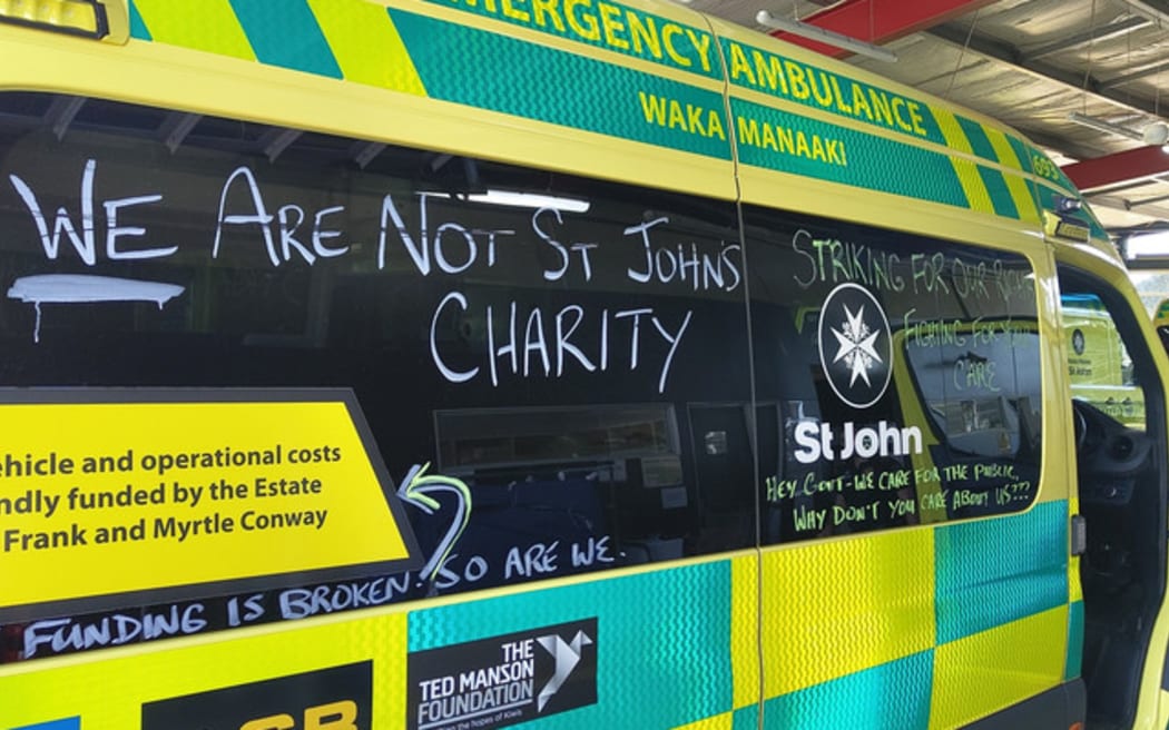 Hato Hone St John First Union members chalking ambulances with messages.