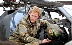 Prince Harry shows a TV crew his flight Helmet as he makes his early morning pre-flight checks at the British controlled flight-line at Camp Bastion in Afghanistan's Helmand Province, where he was serving as an Apache Helicopter Pilot/Gunner, on December 12, 2012.
