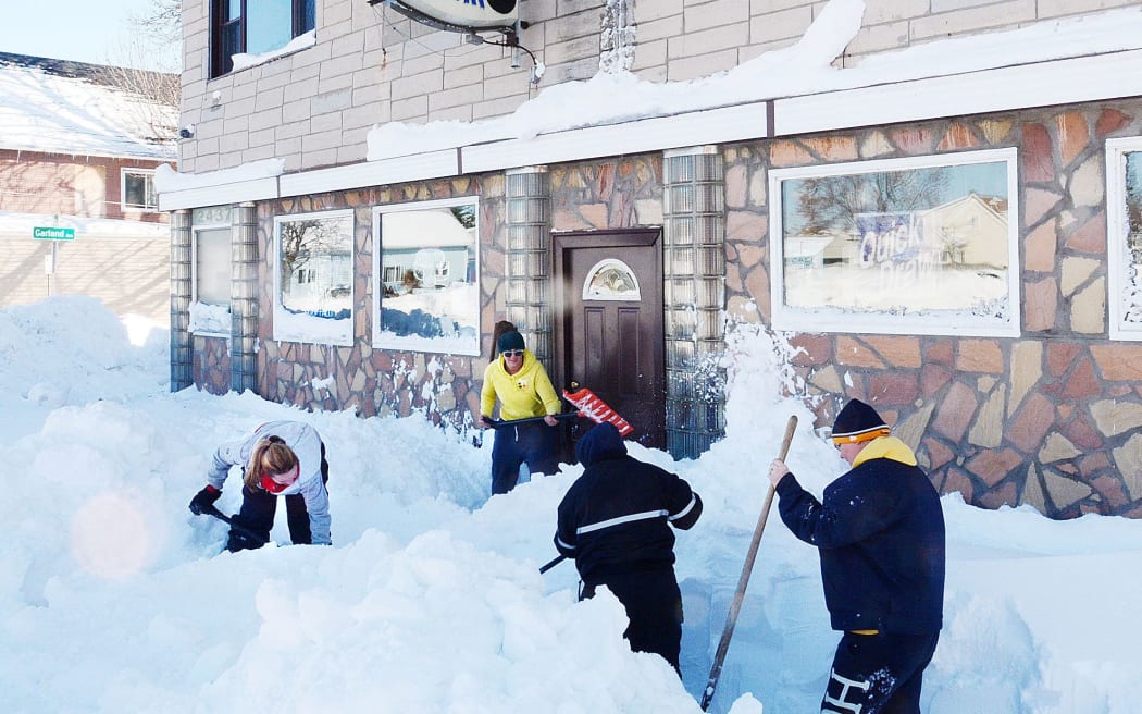 Workers trying to clear snow in Buffalo, New York.