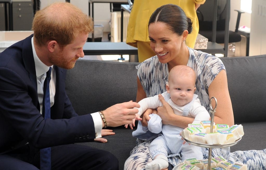 Britain's Duke and Duchess of Sussex, Prince Harry and his wife Meghan hold their baby son Archie as they meet with Archbishop Desmond Tutu (unseen) at the Tutu Legacy Foundation  in Cape Town on September 25, 2019.