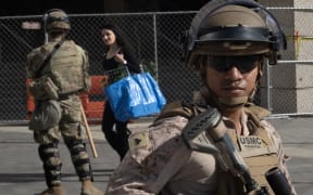 LOS ANGELES, CALIFORNIA - JUNE 17: U.S. Marines and California National Guard stand guard outside of the federal building complex in downtown on June 17, 2025 in Los Angeles, California. California National Guard and U.S. Marines were called in by President Donald Trump to provide security against the wishes of state and local officials following protests in the city, sparked primarily by the immigration policies of the Trump administration.   Scott Olson/Getty Images/AFP (Photo by SCOTT OLSON / GETTY IMAGES NORTH AMERICA / Getty Images via AFP)