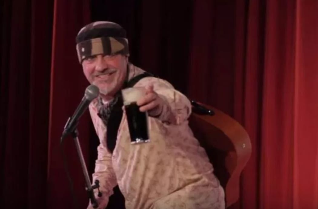 Comedian Ian Cognito addressing the crowd during a performance.