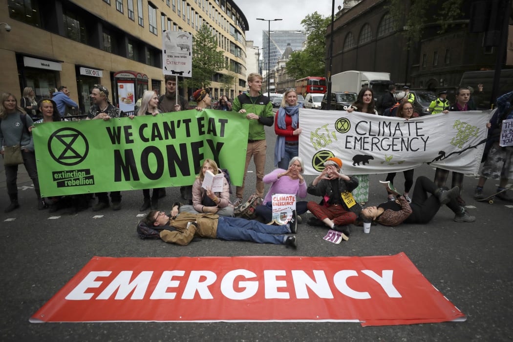 Extinction Rebellion climate change protesters briefly block the road in London, on 25 April, 2019.
