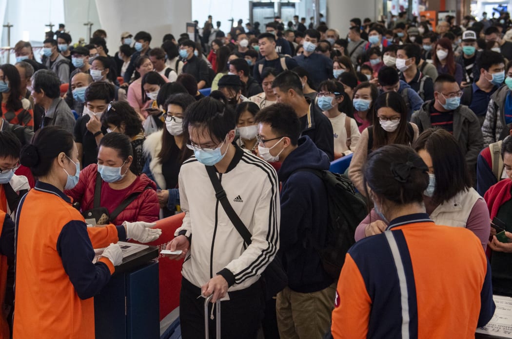 People cover their faces with sanitary masks at an airport in Hong Kong, China.