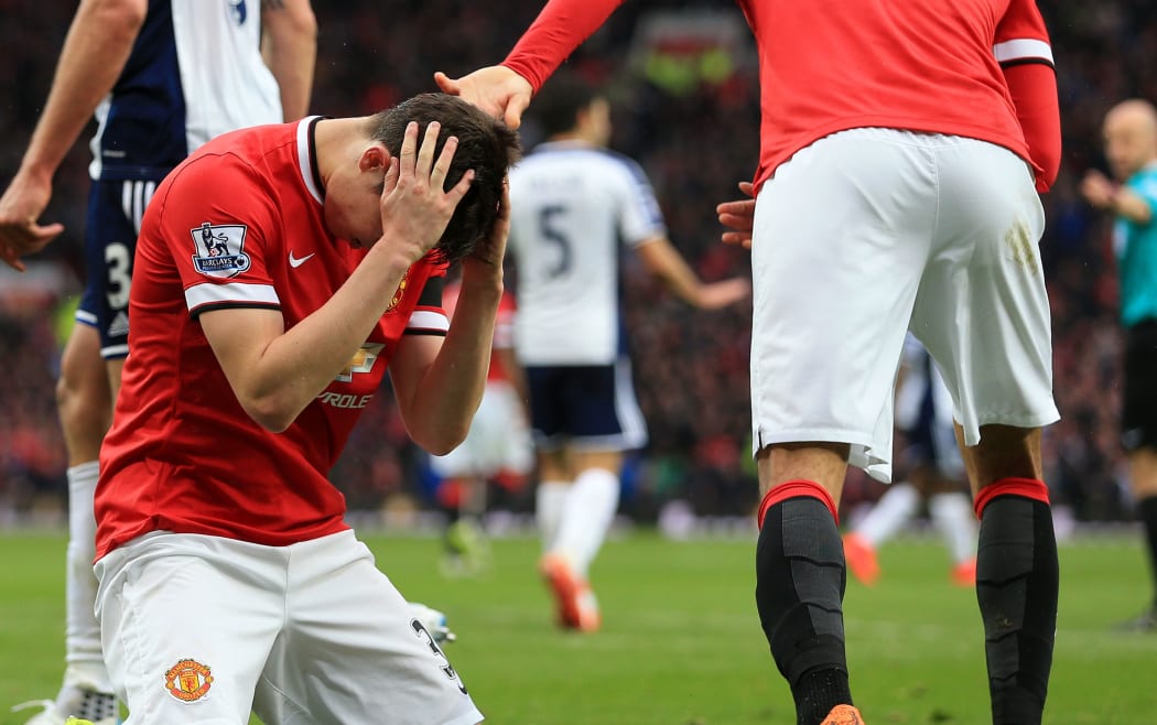 Patrick McNair of Manchester United looks dejected.