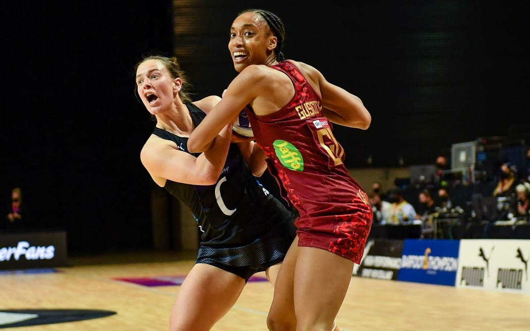 Claire Kersten of the Silver Ferns and Layla Guscoth of England tussle for the balll.