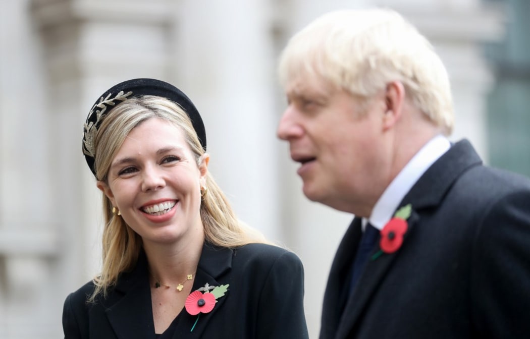 Britain's Prime Minister Boris Johnson (R) and his partner Carrie Symonds attend a Remembrance Sunday ceremony at the Cenotaph on Whitehall in central London.