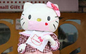 Hello Kitty wearing a mask welcomes visitors at Sanrio Puroland in Tama, Tokyo on July 20, 2020.
