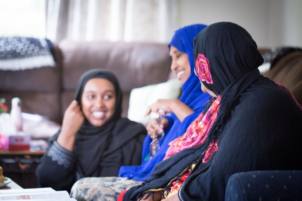 Asha, Muhubo and her mother Amina in Muhubo's new Housing New Zealand home that is large enough for the six adults in her family. Since moving out of their overcrowded house, Muhubo is happier and her health is improving.