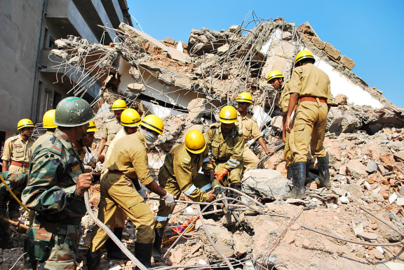 Rescue workers searching the rubble.
