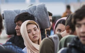 Migrants and refugees wait for a train heading to Serbia from the Greek-Macedonian border