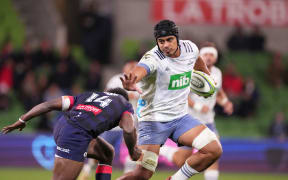 Gerard Cowley-Tuioti of the Blues runs with the ball during team's 50-point demolition of the Melbourne Rebels