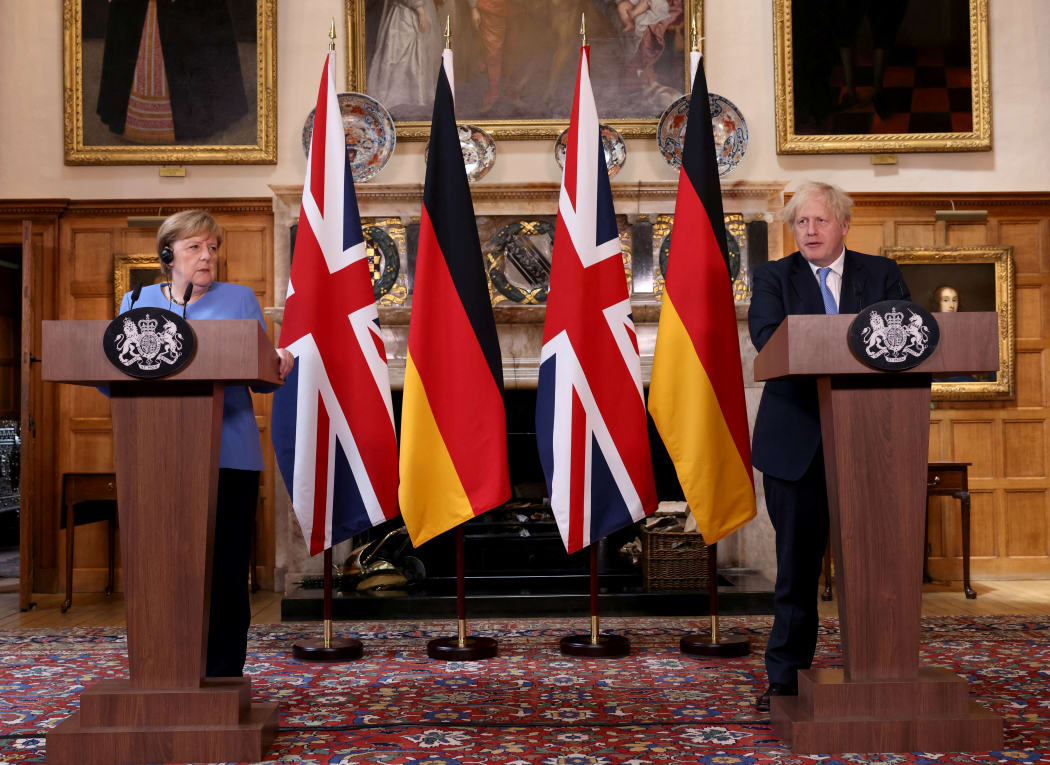 Britain's Prime Minister Boris Johnson (R) and German Chancellor Angela Merkel hold a joint press conference following their bilateral meeting at Chequers, Buckinghamshire on July 2,