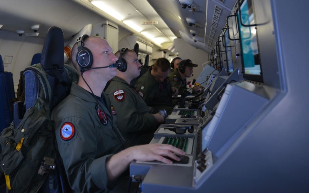 Crew members on board a US P-8A Poseidon searching for Malaysia Airlines MH370 plane which went missing in 2014