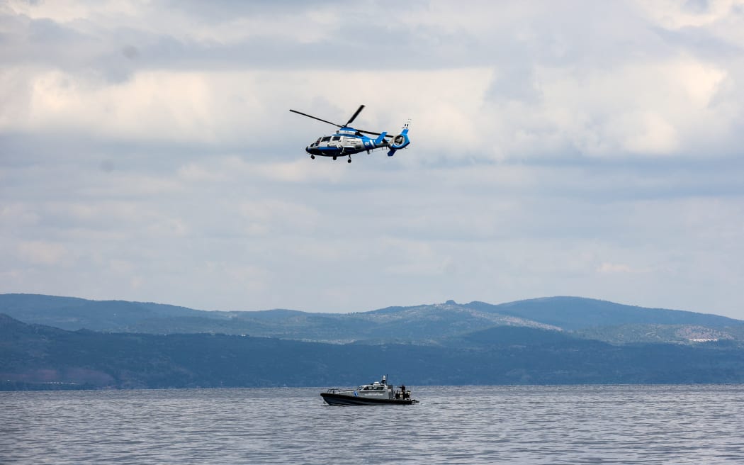 A Greek coast guard vessel and a helicopter take part in a search and rescue operation, after an inflatable boat carrying migrants capsized off on the Aegean Sea island of Lesbos on April 3, 2025.