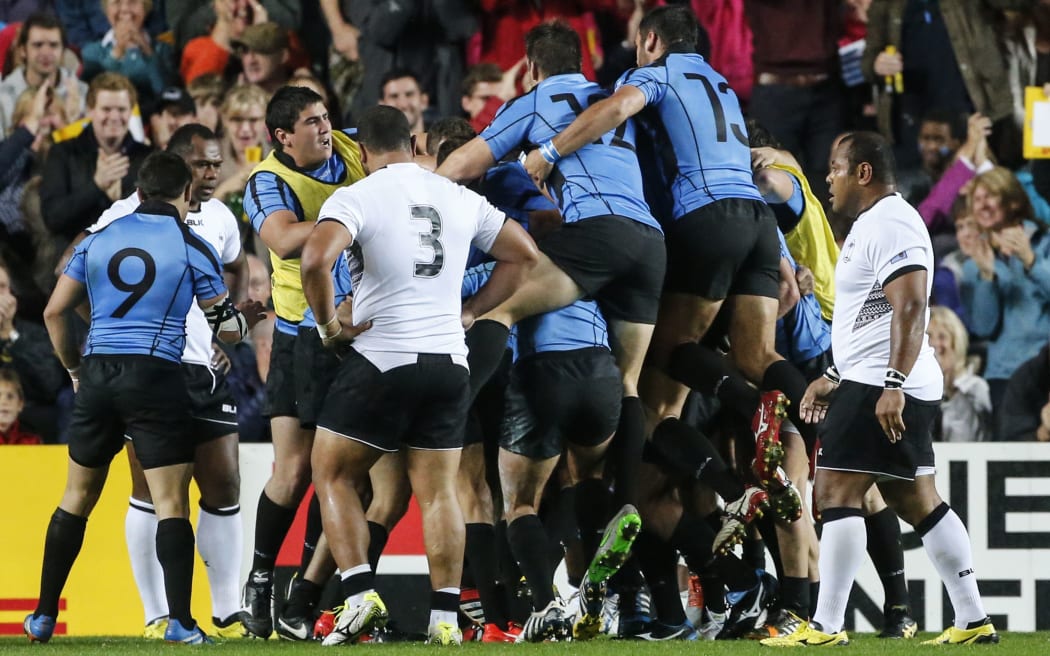 Uruguay players celebrate their first Rugby World Cup try in 12 years.
