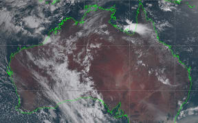 This handout satellite image taken and received on January 3, 2020 from the Japan Meteorological Agency shows an image from the Himawari-8 satellite of Australia, with smoke (bottom R) from bushfires visably drifting off the coast of southeast New South Wales state.