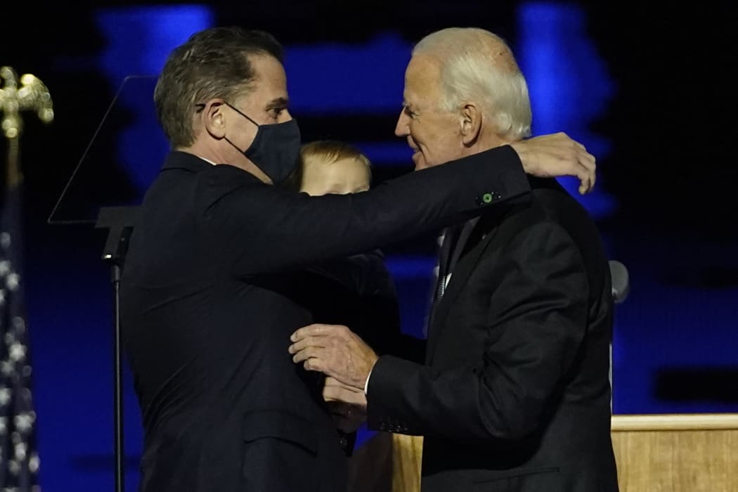 In this file photo taken on November 07, 2020 US President-elect Joe Biden (R) embraces his son Hunter Biden (L) on stage after delivering remarks in Wilmington, Delaware.