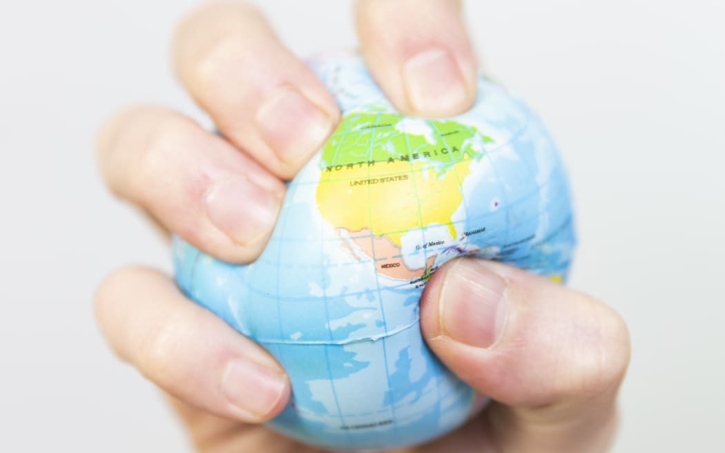 Stress ball 
A man gripping a stress ball in the shape of the earth. 

COLLANGES / BSIP (Photo by COLLANGES / BSIP / BSIP via AFP)