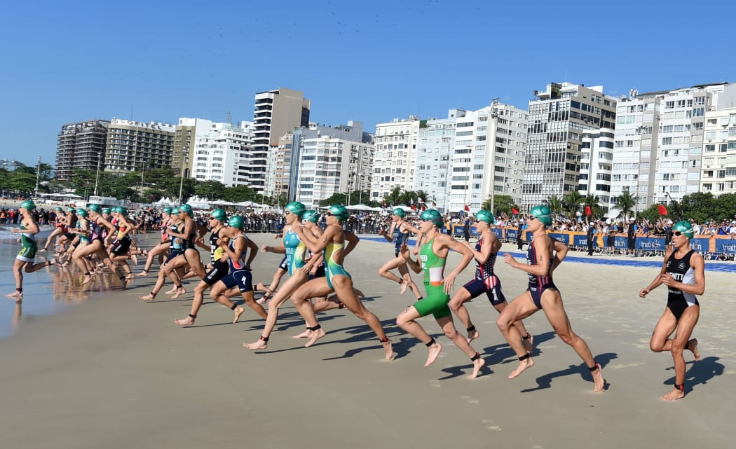 Triathletes competing at Copacabana Beach.