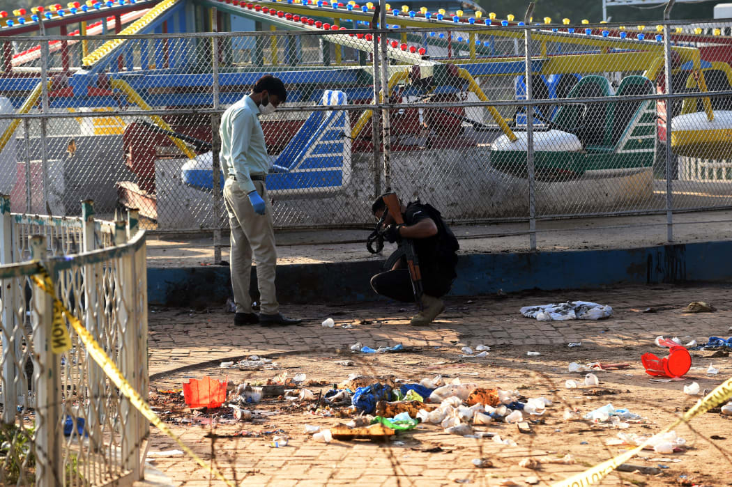 Pakistani security officials collect evidence at the cordoned-off site of the March 27 suicide bombing, in Lahore on March 28, 2016.