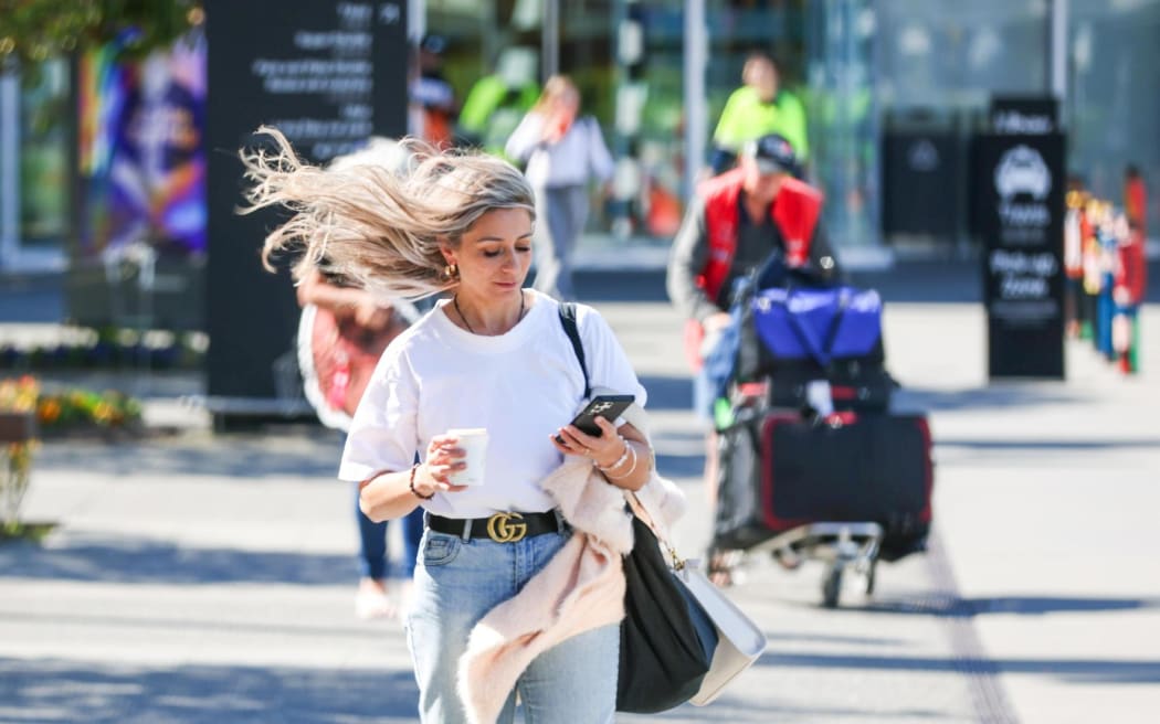 People leaving Christchurch Airport after mass cancellations due to the weather.