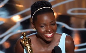 Lupita Nyong'o accepts the Oscar for best supporting actress for 12 Years a Slave.