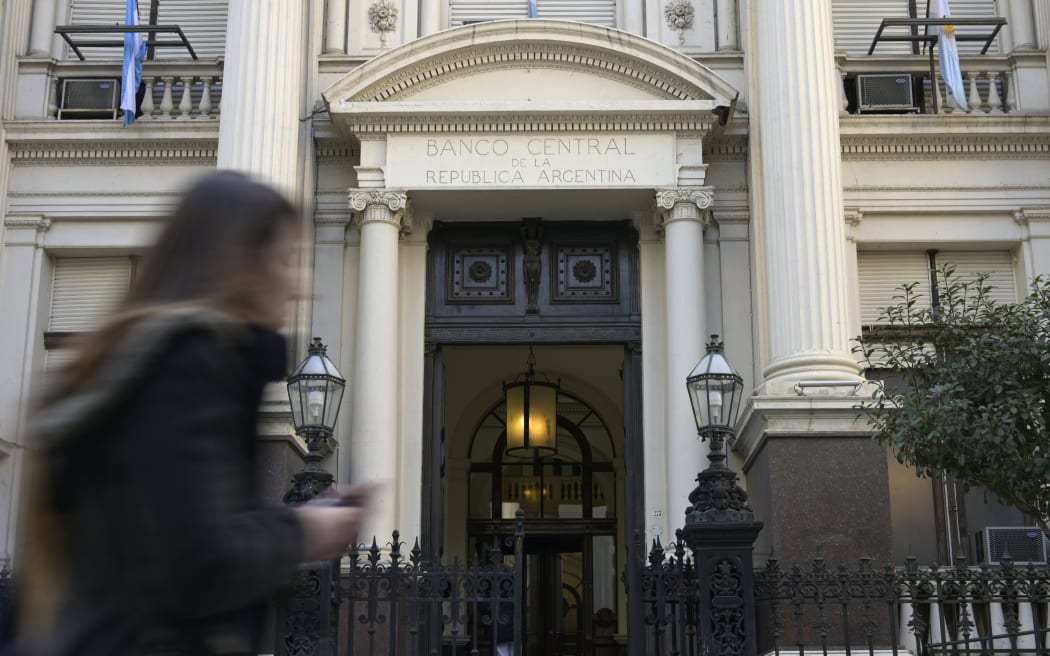 A woman passes by the headquarters of Argentina's Central Bank in the financial district of Buenos Aires