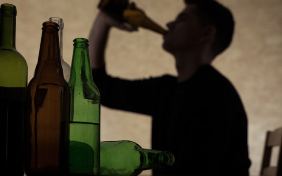 Teen chugging a beer.