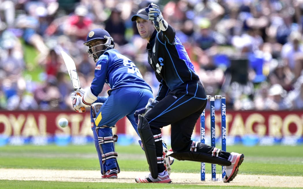 Nuwan Kulasekara bats as New Zealand's wicketkeeper Luke Ronchi  looks on during the first one-day international cricket match between the Black Caps and Sri Lanka at Hagley Park in Christchurch.