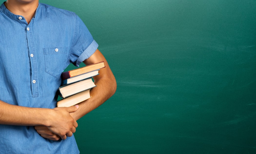 young man holding books