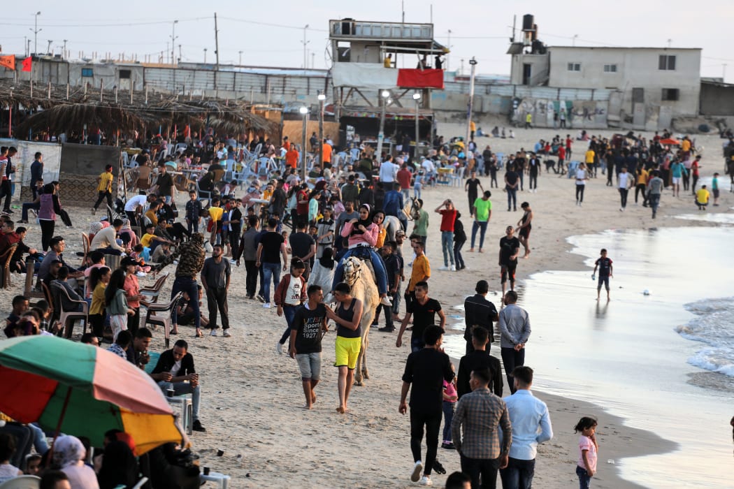 Palestinians gather by the seaside during the Eid al-Fitr in Gaza City on May 26, 2020 amid the coronavirus Covid-19 pandemic.