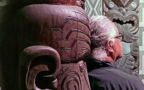 Hoturoa Barclay-Kerr with ancestors in the wharenui at Waitangi
