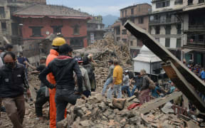 Rescue teams work to clear rubble in the capital's Durbar Square.