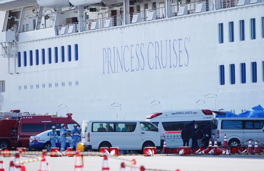 Passenger patients on board the Princess Diamond,  who have tested positive for the novel coronavirus are carried to an ambulance at the Yokohama port.