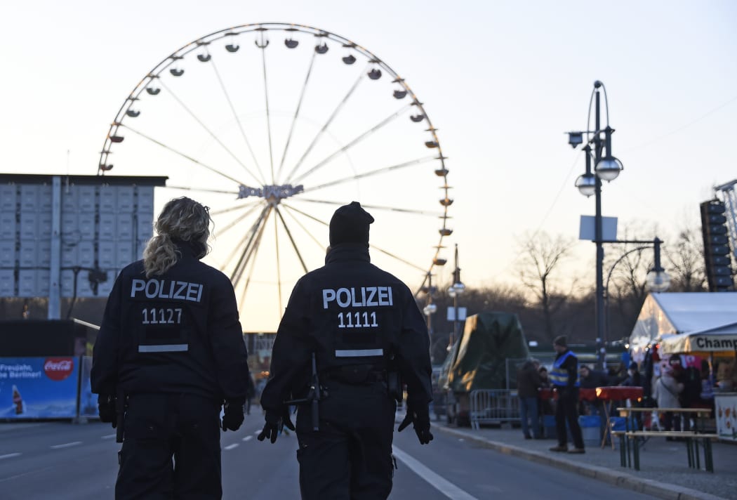 Police patrol at the fair grounds ahead of the New Year's Eve party near the Brandenburg Gate in Berlin.