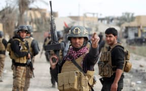 Members of Iraq's elite counter-terrorism service secure the Hoz neighbourhood in central Ramadi.