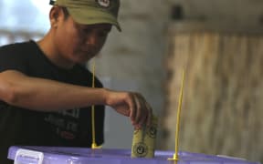 A voter casts his ballot at a polling station in Myanmar's Rakhine state.