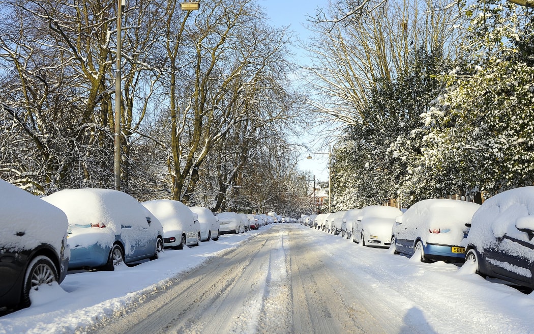 Cars are covered in snow in Glasgow.
