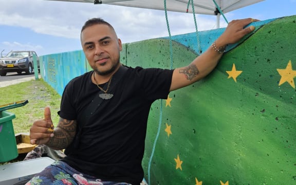 Artist Gonzalo Aldana completes the final panel of the mural.