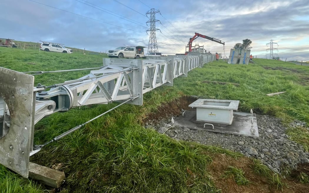 A temporary tower lies on a farm in Northland on 21 June 2024 as Transpower crews prepare to install it after a fallen pylon cut power to thousands of Northland properties.