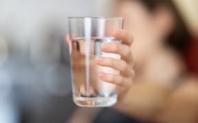 hand holding a glass of water