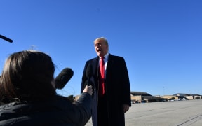 US President Donald Trump speaks to reporters.