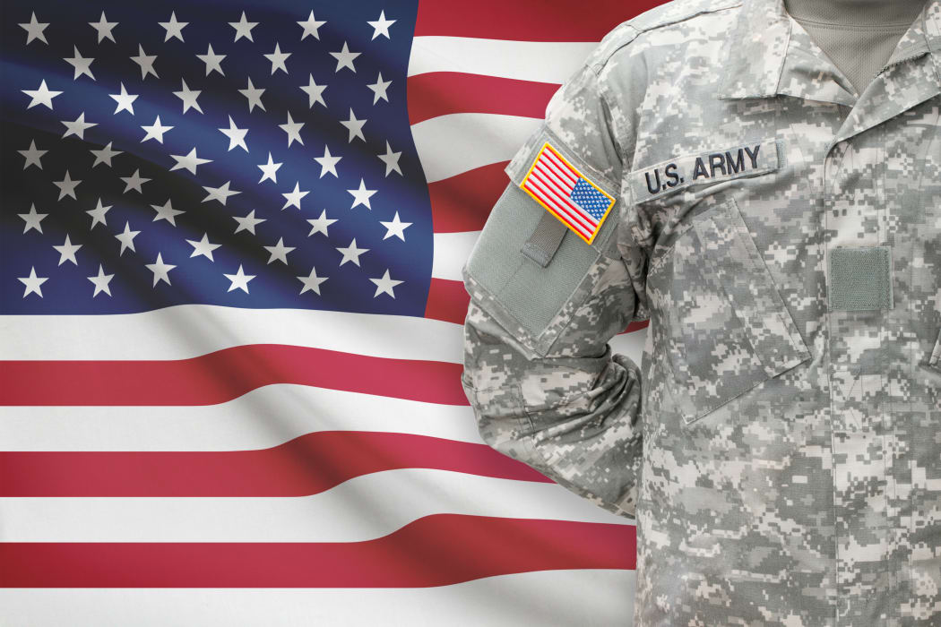 American soldier with flag on background - United States