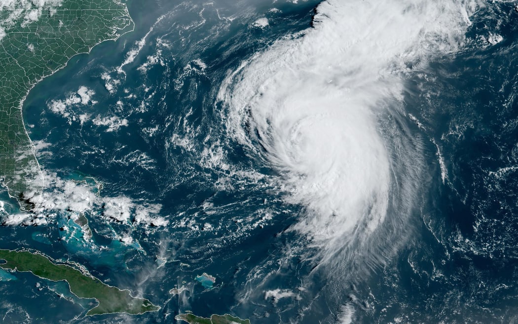 This satellite image obtained from the National Oceanic and Atmospheric Administration shows Hurricane Ernesto at 12:50 Zulu on August 16, 2024. Ernesto, a Category 2 hurricane, is moving towards Bermuda prompting hurricane warnings.  The US National Hurricane Center said Ernesto was located about 320 miles (515kms) south-southwest of Bermuda, with maximum sustained winds of 100 mph (161kph). (Photo by Handout / NOAA/GOES / AFP) / RESTRICTED TO EDITORIAL USE - MANDATORY CREDIT "AFP PHOTO / NOAA/GOES" - NO MARKETING NO ADVERTISING CAMPAIGNS - DISTRIBUTED AS A SERVICE TO CLIENTS