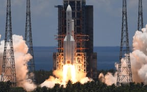 A Long March-5 rocket, carrying an orbiter, lander and rover as part of the Tianwen-1 mission to Mars, lifts off from the Wenchang Space Launch Centre in southern China's Hainan Province on 23 July 2020.