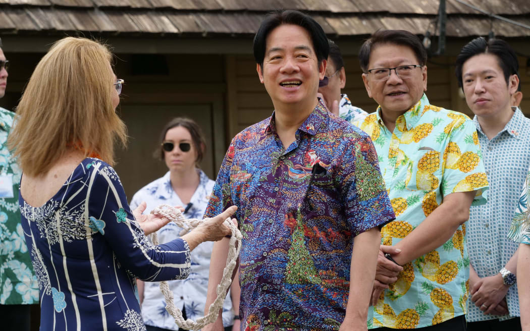 Bishop Museum director Dee Jay Mailer presents Taiwanese President Lai Ching-te with a rope lei during his visit to the museum in Honolulu, Hawaii, on November 30, 2024. - Taiwan President Lai Ching-te arrived Saturday in the United States for the start of a week-long tour in the Pacific that he said would usher in a new era of democracy, but has sparked fury in Beijing. (Photo by Ronen ZILBERMAN / AFP)