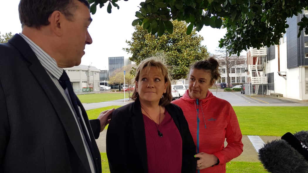 Inspector Scott Miller, Lois Tolley's aunt Yvonne Tolley, and a support person outside of court.