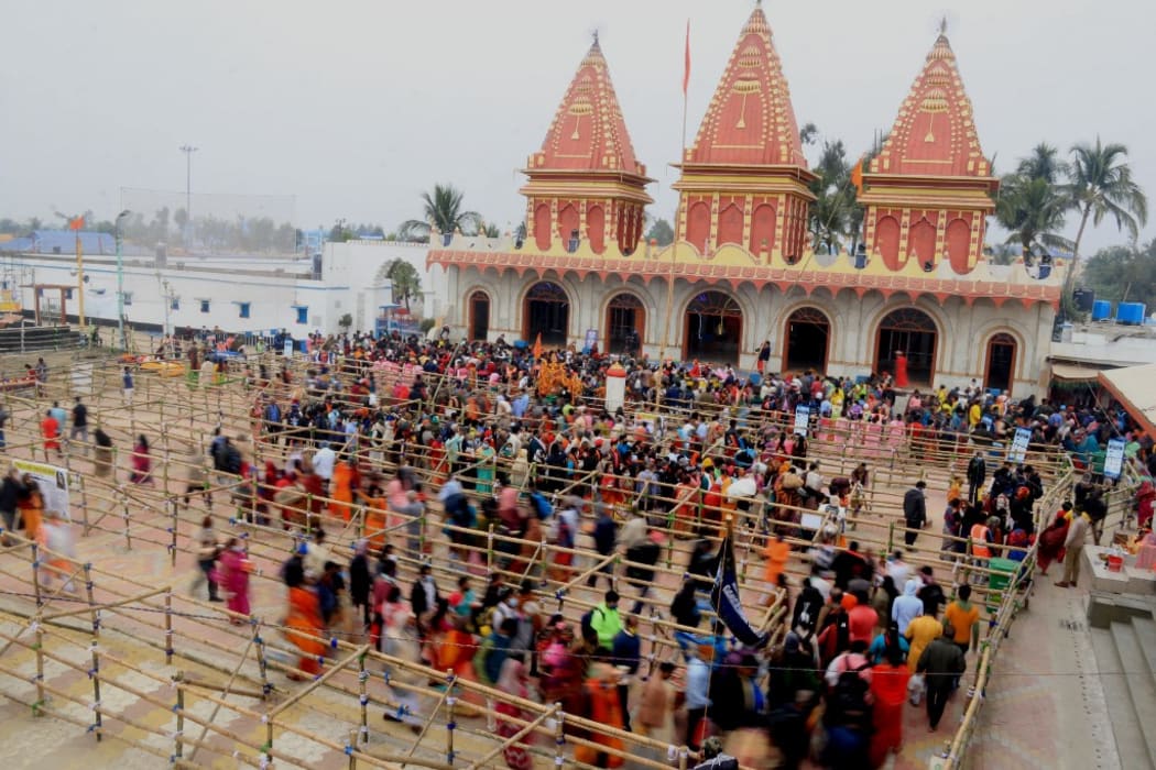 In this aerial photo taken on January 14, 2021,Hindu devotees gather pray puja to Kapilmuni temple  during the Gangasagar Mela, at Sagar Island, some 150 kilometres south of Kolkata.