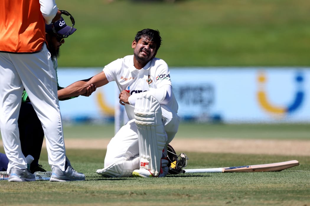 Bangladesh's Mehidy Hasan Miraz receives attention to his arm during play on day four of the first cricket test between Bangladesh and New Zealand at Bay Oval